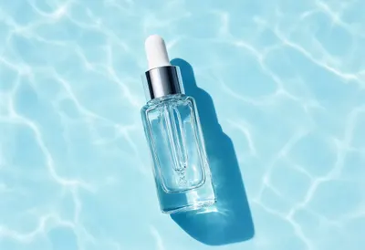 Clear Glass Dropper Serum with Blue Water Reflections 2