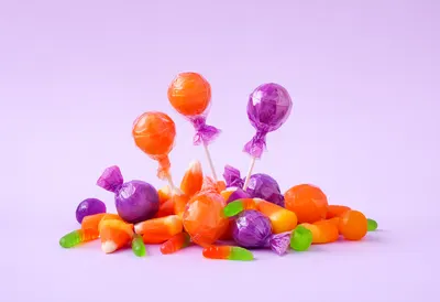 Colorful Halloween Candy on a Light Purple Background (AI-generated)