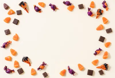 Halloween Candy Border with Copy Space on Cream Background (AI-generated)