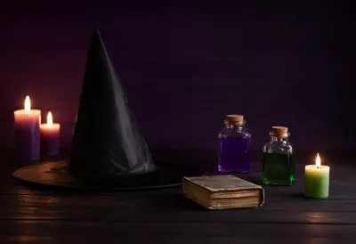 Dark Witch Hat, Magical Potions and Candles on a Rustic Table (AI-generated)