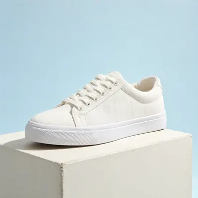 Minimal White Canvas Sneakers on a Display Pedestal