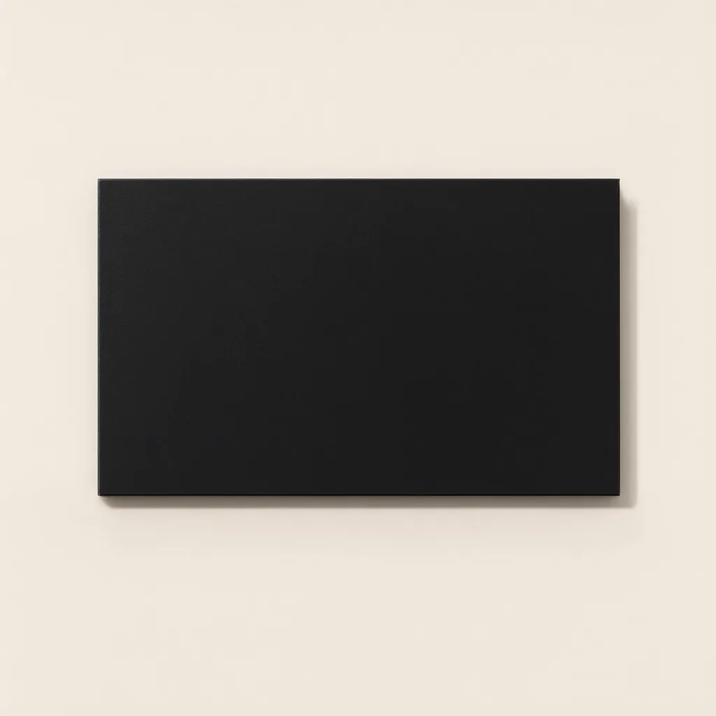 Plain black hardcover book with a blank cover placed horizontally on a beige background. (AI-generated)