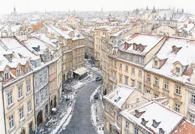 Historic European City Street Covered in Snow (AI-generated)