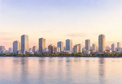 Modern City Skyline at Sunset by the Waterfront (AI-generated)
