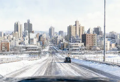 Snow Covered City Street with Modern Buildings (AI-generated)