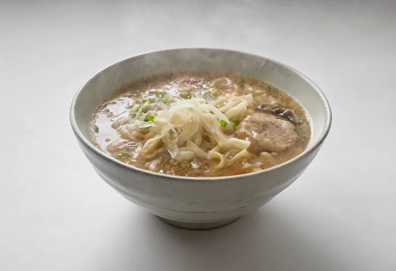 Steaming bowl of ramen under soft studio lighting (AI-generated)