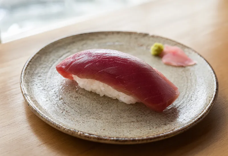 Fresh tuna nigiri sushi on a handcrafted ceramic plate (AI-generated)