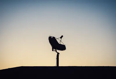 Satellite Dish Silhouette at Dusk (AI-generated)