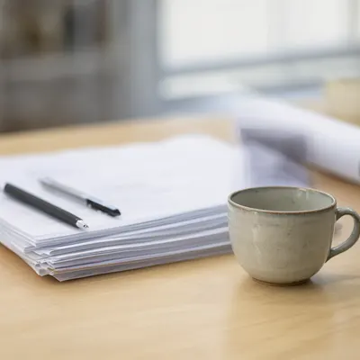 Coffee Cup and Documents on a Desk (AI-generated)