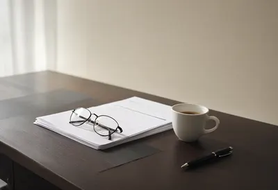Executive Desk with Documents and Reading Glasses (AI-generated)