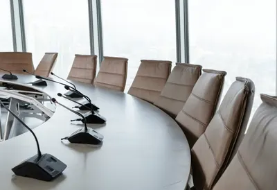 Conference Table with Leather Chairs and Microphones