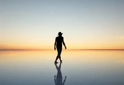 Woman with a Hat Walking a Salt Flat