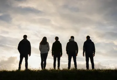 Group of Five on a Hilltop Watching Clouds