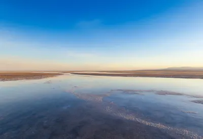 Salt Flats Mirroring The Sky at golden hour