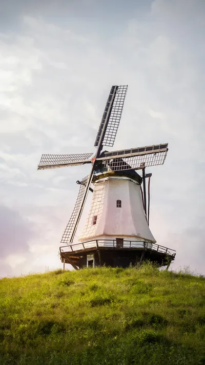 Fantasy Windmill On A Grassy Hill in a soft palette