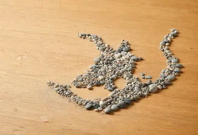 Road Map Made Of Small Pebbles On Sand on a warm wooden table