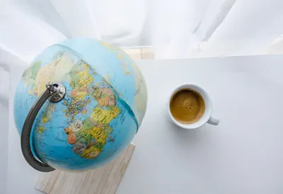 Globe And A Cup Of Coffee At A Window as a flat lay from above