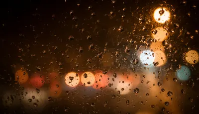 Bokeh City Lights Through A Wet Window in a warm palette