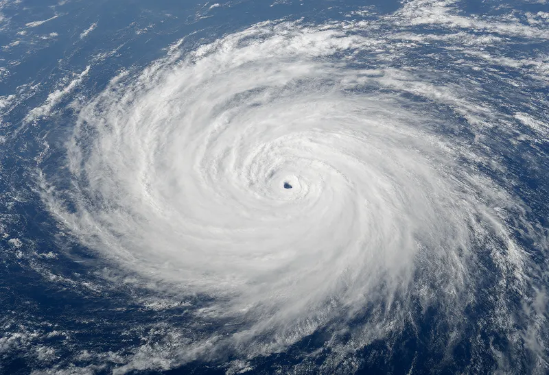 Tropical cyclone with a defined eye seen from high altitude over the ocean