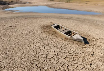Drought Cracked Reservoir with an Abandoned Boat