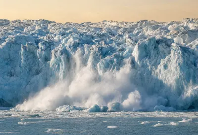 Glacier Calving into the Sea at Dusk