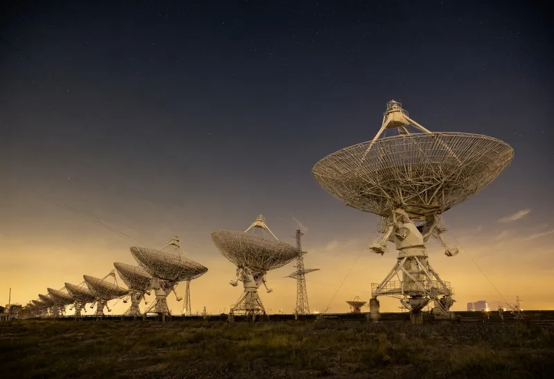 Radio Telescope Array under Stars at Dusk