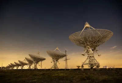 Radio Telescope Array under Stars at Dusk