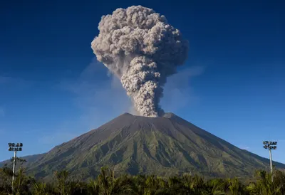 Volcano Erupting with Ash Plume at Night