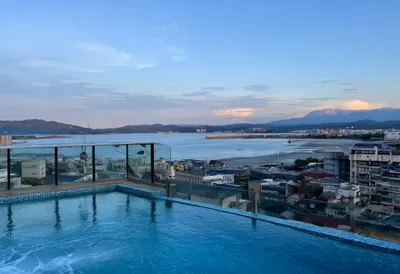 Rooftop Pool Overlooking A Bay at blue hour