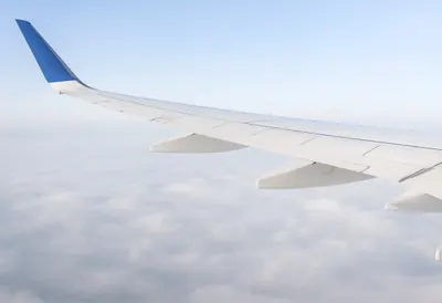 Airplane Wing Above A Sea Of Clouds in soft mist