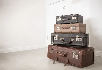 Stack Of Vintage Suitcases In A Bright Hallway as a flat lay from above