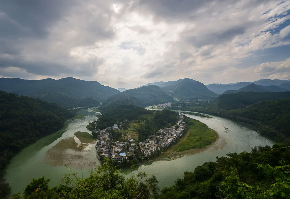 River Winding Through Green Hills From Above under a dramatic sky