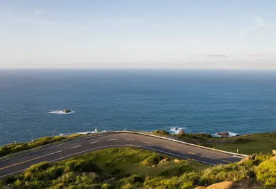 Coastal Road Curving Above The Sea from above