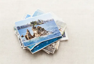 Stack Of Travel Postcards On Linen as a flat lay from above