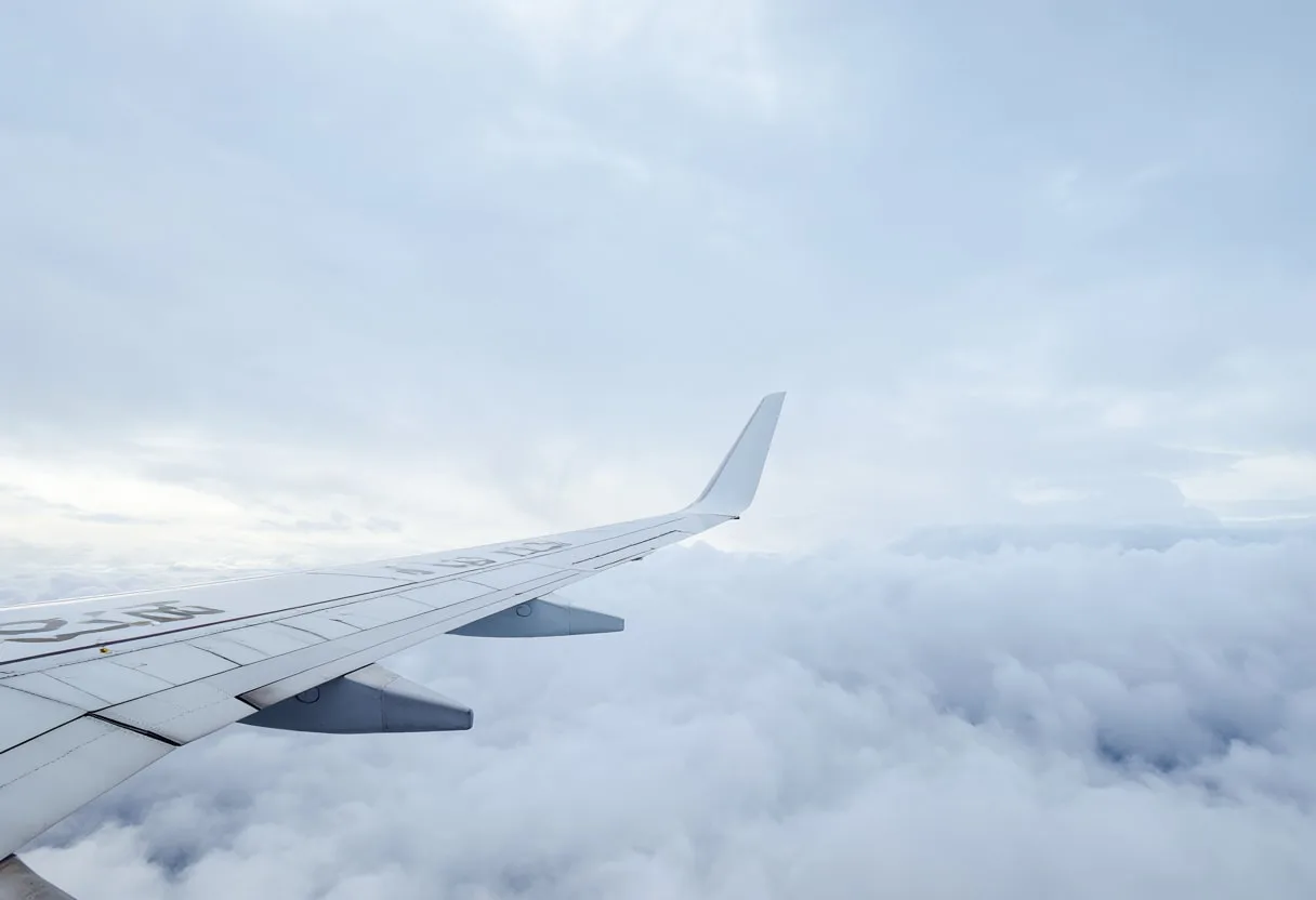 Airplane Wing Above A Sea Of Clouds in the rain