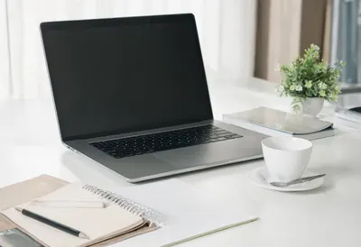 Desk with Laptop and Notebook