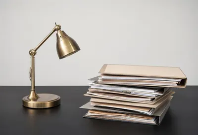 Stacked Folders and a Lamp in a minimal setting