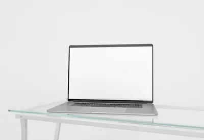 Laptop on a Glass Desk in a clean studio