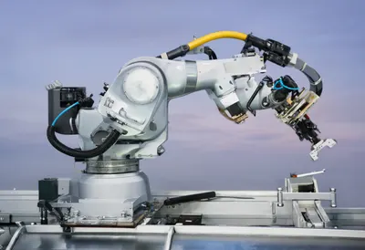 Robot Arm on an Assembly Line at dusk