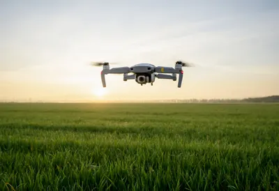 Drone Hovering above a Field at dusk