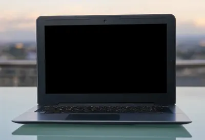 Laptop on a Glass Desk at dusk