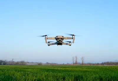 Drone Hovering above a Field with cool blue light