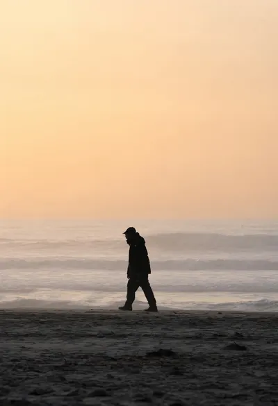 Silhouette on a Beach at Sunset in soft mist