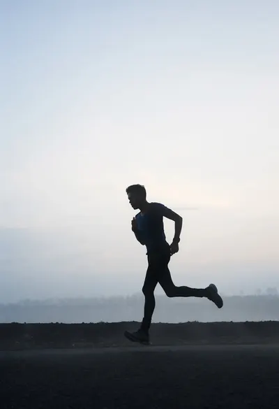 Runner Silhouette at Dawn in soft mist