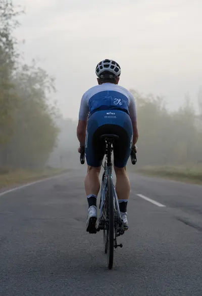 Silhouette of a Cyclist at Dusk in soft mist