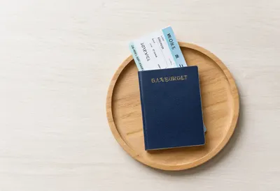 Passport And Boarding Pass On A Wooden Tray as a flat lay from above