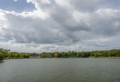 Park lake with dramatic clouds, wide angle