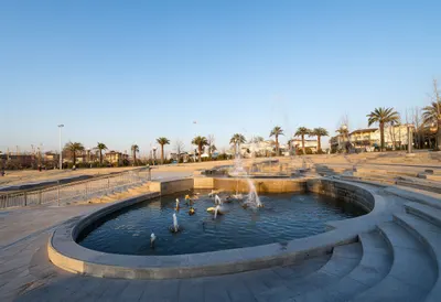 Fountain plaza at golden hour, wide angle