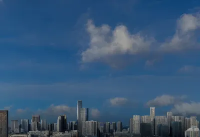 Night skyline with dramatic clouds, low angle