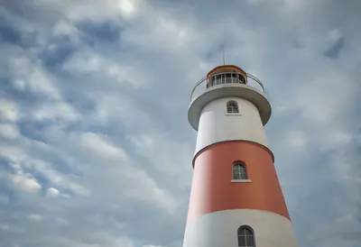 Lighthouse with dramatic clouds, low angle